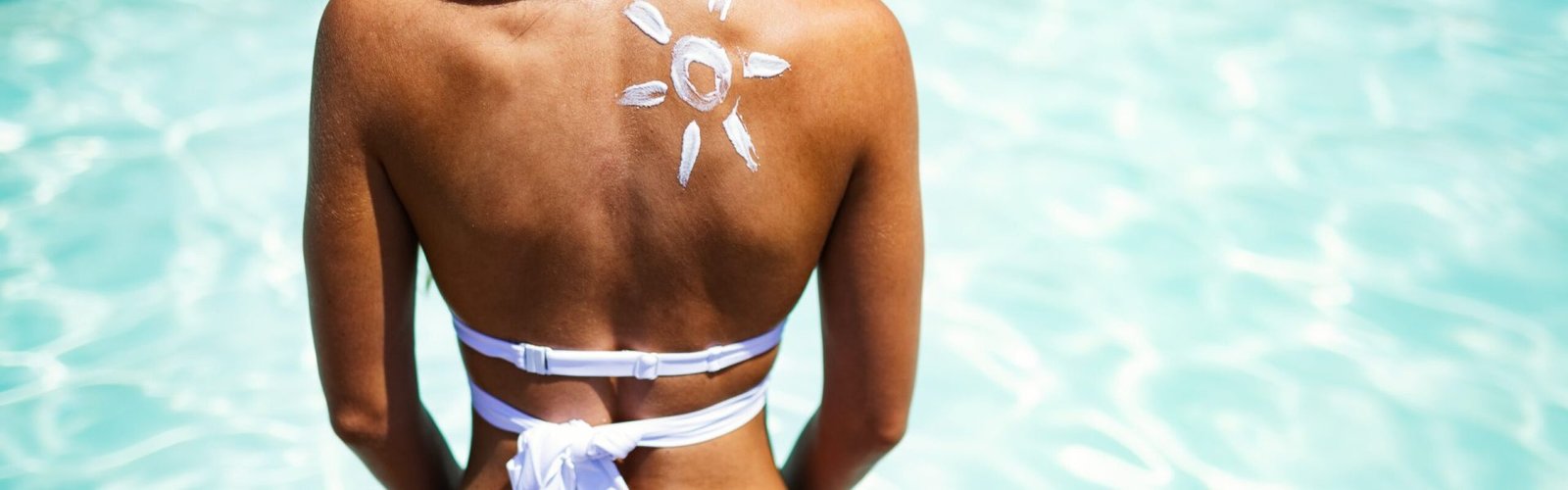 attractive-woman-with-healthy-skin-applying-sunscr-2023-11-27-05-00-55-utc-min